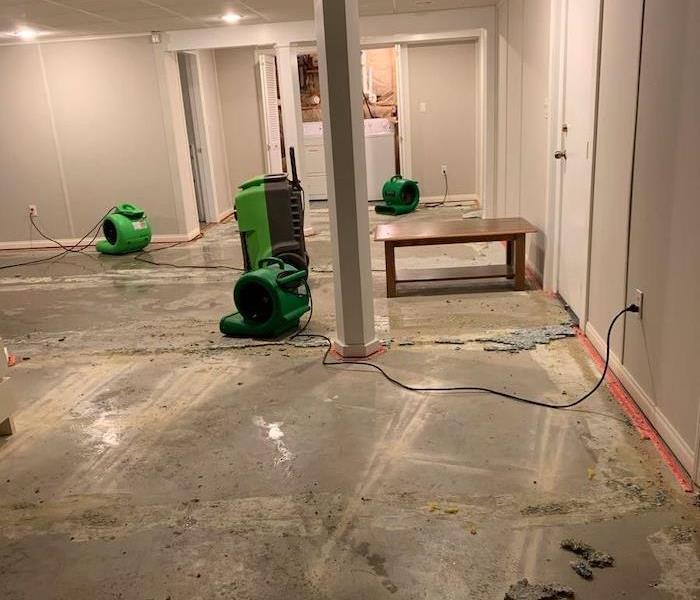 Basement with slab floor and SERVPRO drying equipment