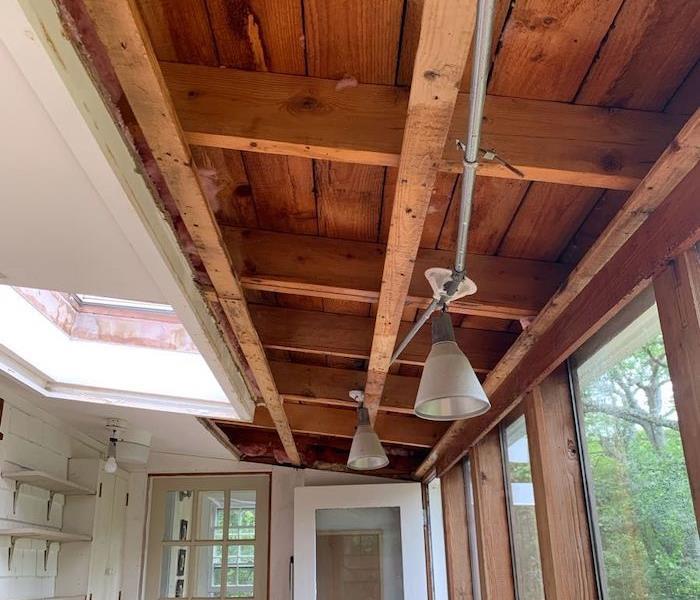 Home ceiling with removed sheetrock and framework exposed