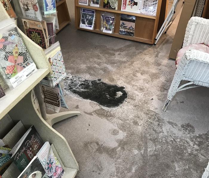 Bookstore with a charred area in the floor