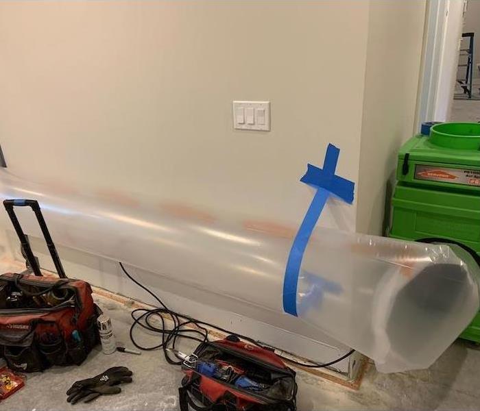 SERVPRO drying equipment in room with tools