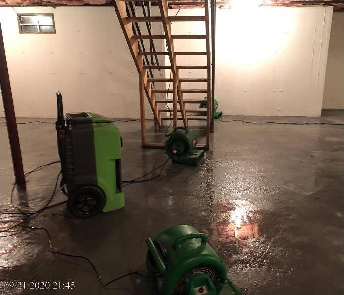 SERVPRO restoration equipment being used in water damaged basement