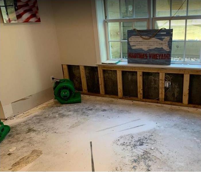 water damaged room; SERVPRO drying equipment being used; flood cuts on drywall to enable drying
